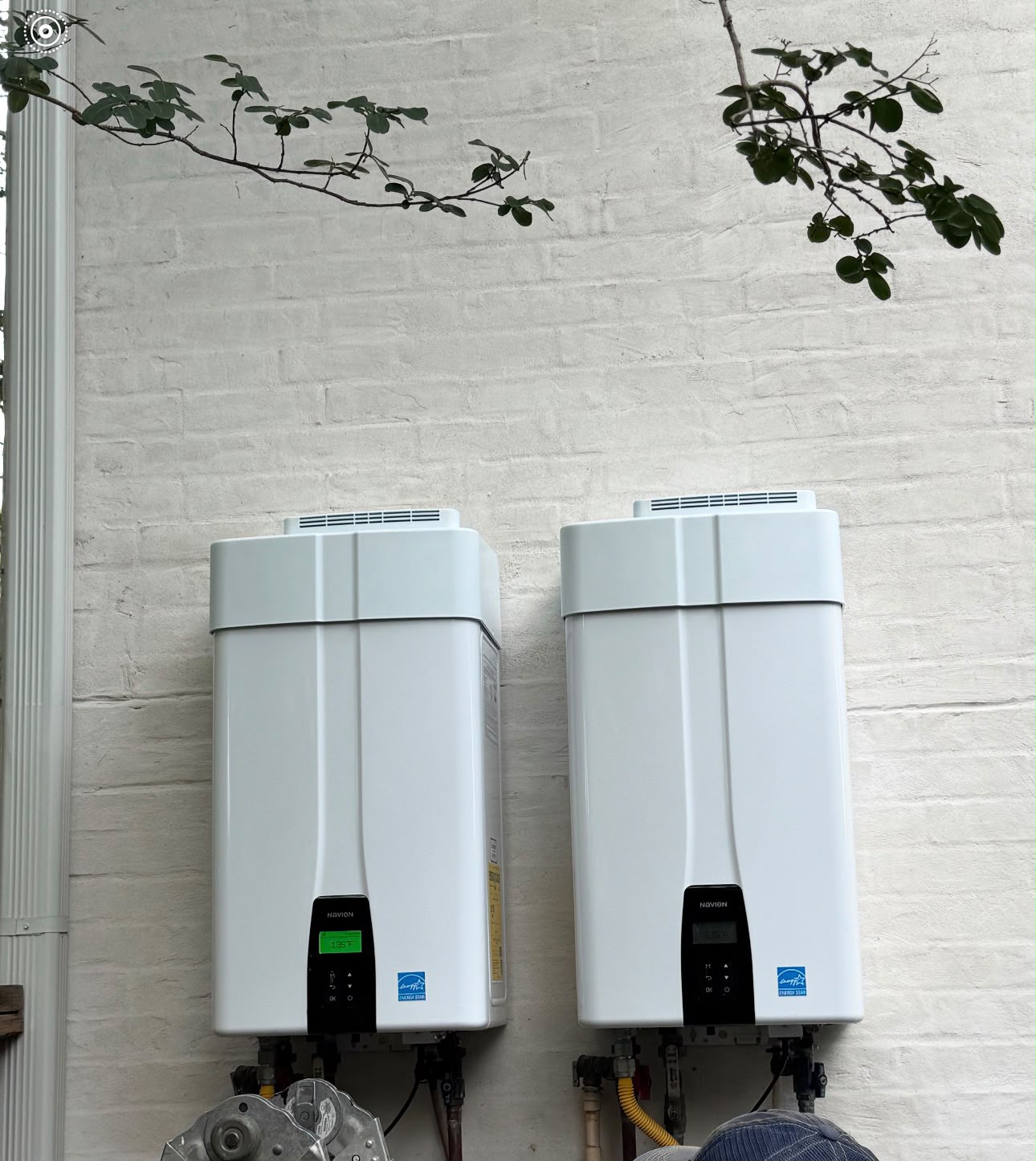 Two high-efficiency tankless water heaters mounted side by side on a Houston home in the Upper Kirby area (77027)