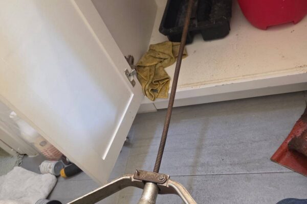 Drain machine cable snaking a sink drain line at the wall stub-out in Katy TX 77450