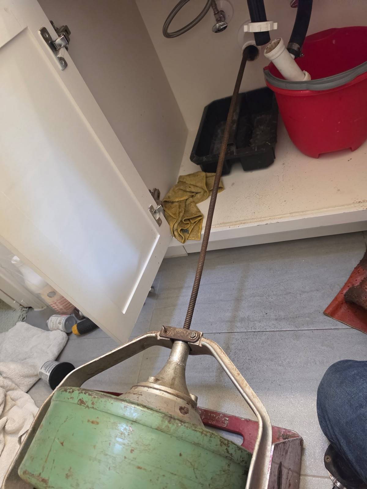 Drain machine cable snaking a sink drain line at the wall stub-out in Katy TX 77450