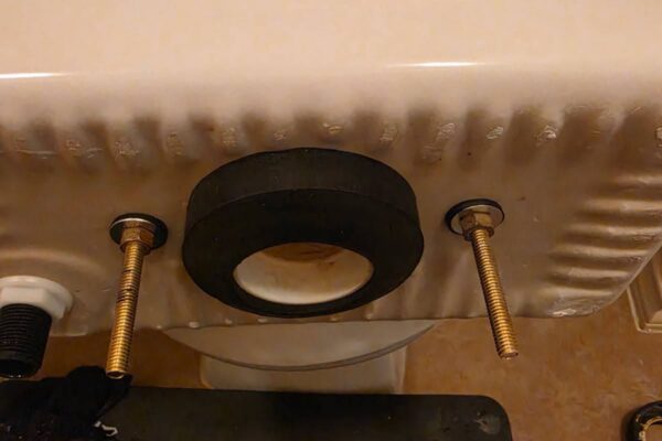 New tank-to-bowl sponge gasket and brass bolts on a toilet tank in West University Place Houston 77005